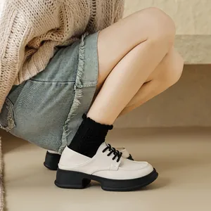 Platform loafers for women in beige with black thick soles and lace-up details