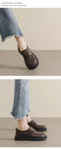 Detailed side view of dark brown platform Mary Jane loafers with vintage double buckle straps