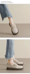 Detail view of beige platform loafers with double metal buckles and matte finish