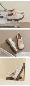 Detail of beige Mary Jane loafers with double buckle straps and chunky rubber soles