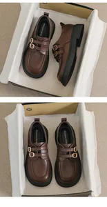 Detail view of brown leather platform loafers with double buckles and thick rubber soles