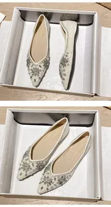 Macro shot of pointed-toe flats featuring snowflake rhinestone patterns and sequins