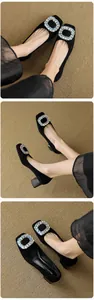 Macro detail of black square-toe pumps with sparkling rhinestone buckle and block heel