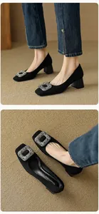 Detail of black suede square toe block heel shoes with sparkling rhinestone buckle