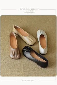 Top view of pleated round toe flat shoes in four colors on a soft neutral carpet