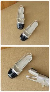 Detail view of bicolor flat sandals with pearl strap and silver metallic leather texture