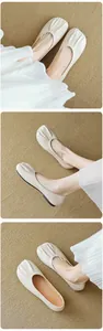 Close-up of ruched square toe design on beige ballet flats with soft leather texture