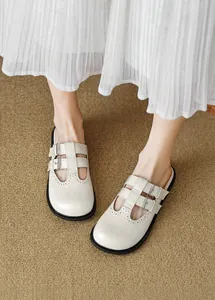 Close-up of cream white brogue mule with double buckles and anti-slip thick sole