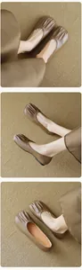 Macro detail of brown leather ballet flats featuring pleated round toes and soft soles