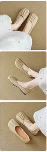 Close-up of beige round toe ballet flats with retro pleated leather detail