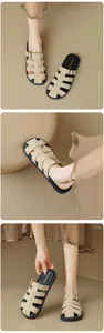 Detail of beige woven roman gladiator sandals with metal buckle and chunky black sole