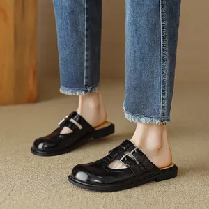 Classic black patent leather Mary Jane mules with stylish silver buckles and flat soles