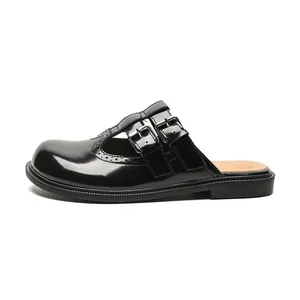 Elegant black patent leather Mary Jane mules with brogue detailing and T-strap metal buckles
