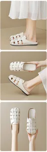 Detail of cream woven leather mules showing the cross-stitch texture and flat sole