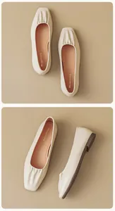 Macro detail of square toe ballet flats with ruched cream leather and orange insoles