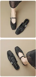 Detailed view of black velvet mule flats with a sparkling rhinestone buckle and square toe