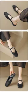 Detail of black satin Mary Jane flat with square toe and sparkling rhinestone buckle