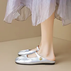 Silver metallic Mary Jane mules with pleated toe and decorative gold buckle detail