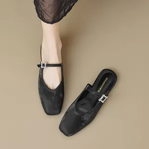 Elegant black square-toe Mary Jane mules with sparkly fabric and rhinestone buckles