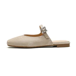 Champagne gold pointed mule flats with shimmering rhinestone buckle and marble texture