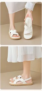 Detail view of white cross-strap platform sandals with khaki non-slip soft sole