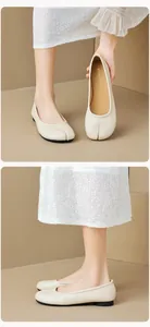 Detail of beige split-toe Tabi flats showing front view and side profile on feet