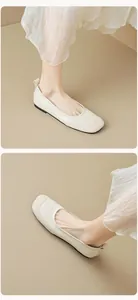 Detail shot of elegant off-white square toe ballet flats with stylish material splicing