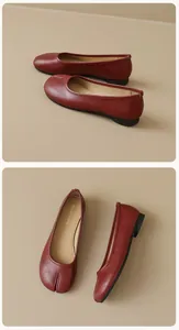 Detailed view of dark red Tabi split-toe flat shoes made of matte textured leather