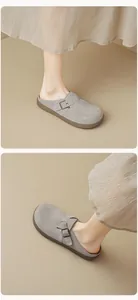 Detail view of grey suede platform mule slippers with adjustable metal buckles and rubber soles
