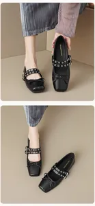 Detail of black square-toe Mary Jane flats with bow and double grommet straps