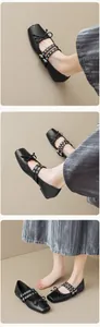 Detail of black square-toe Mary Jane flats with double straps and bow decoration