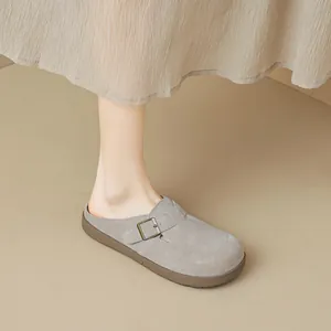 Grey suede platform mule clogs with adjustable bronze buckle on a comfortable rubber sole