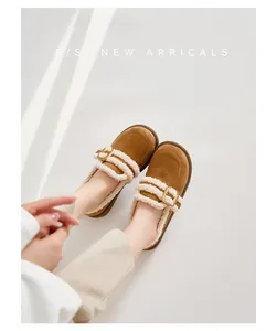 Detail von braunem Wildleder-Loafer mit warmem Fleecefutter und goldener Metallschnalle