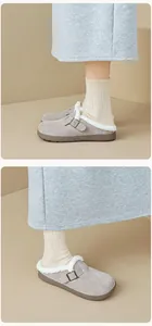 Detail view of grey suede clogs with plush white faux fur lining and metal buckle
