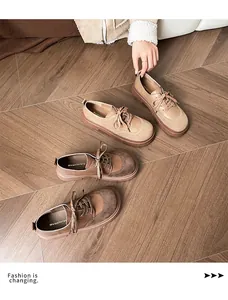 Close-up of retro lace-up loafers featuring mixed matte leather textures and chunky soles