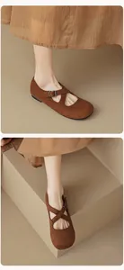 Close-up of retro Mary Jane flats featuring cross straps and brushed suede finish