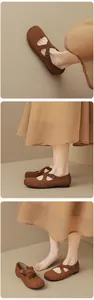 Close-up of brown suede Mary Jane ballet flats with adjustable crisscross straps