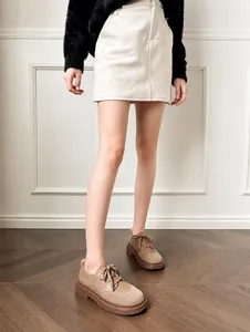 Detailed view of brown suede platform derby shoes with round toe and lace-up design