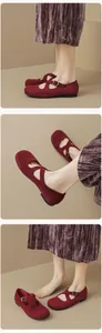 Detailed view of dark red velvet Mary Jane flats with cross straps and vintage round toe