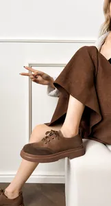 Close-up of lightweight brown rubber sole and premium leather texture on vintage loafers
