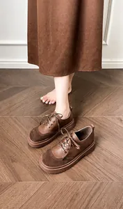 Detail of dark brown patchwork retro chunky platform shoes with lace-up oxford style