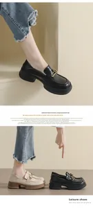Close-up of platform loafers with golden heart buckles in beige and black colors