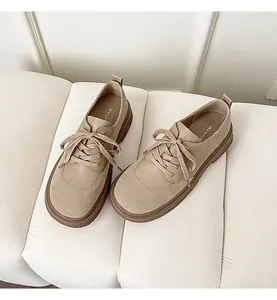 Detail of khaki round-toe platform loafers featuring smooth and suede leather textures