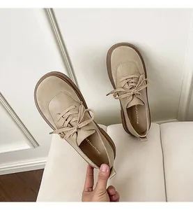 Macro detail of beige retro oxford shoes with platform soles and lace-up design
