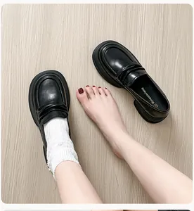 Close-up of matte black leather platform loafer showing inner lining and size mark