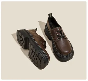 Detalle de mocasines plataforma marrón oscuro con cordones negros y suela dentada