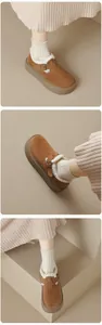 Close-up of brown platform Birkenstock-style clogs with cozy white fur lining and metal buckle