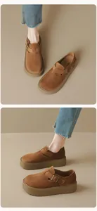 Detail view of brown suede platform clogs featuring metal buckle and thick sole