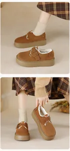 Close-up of brown suede platform snow boots with fleece lining and metal buckle detail