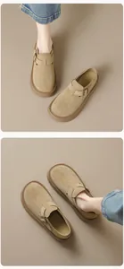 Close-up of beige suede platform clogs with adjustable metal buckle and thick rubber sole